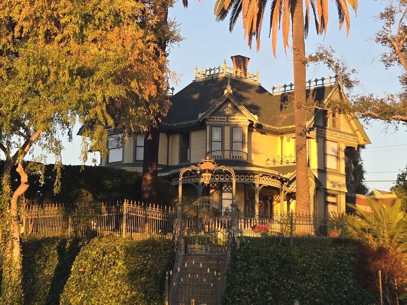 Queen Anne entry, patterned trim, bay windows, roof cresting, and porch details on the Albert H. Beach House